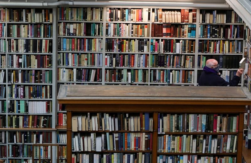 A man chooses a book at the Literary and Philosophical Society of Newcastle upon Tyne, as it reopens its doors to socially distanced customers. Reuters