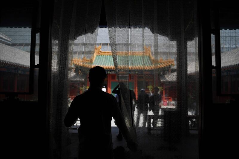 Muslim men leave after prayers on the first Friday of Ramadan at a mosque in Beijing.   AFP