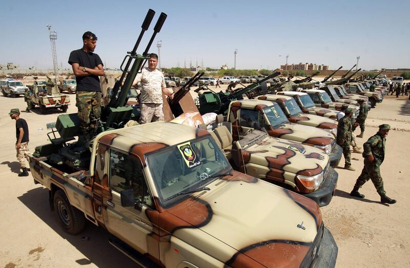 (FILES) A file photo taken on June 18, 2020 shows members of the self-proclaimed eastern Libyan National Army (LNA) special forces gather in the city of Benghazi, on their way to reportedly back up fellow LNA fighters on the frontline west of the city of Sirte, facing forces loyal to the UN-recognised Government of National Accord (GNA).  A surprise ceasefire announcement by Libya's rival administrations offers a glimmer of hope for peace, but analysts caution scepticism after years of violence and as multiple foreign forces back opposing sides. Fayez al-Sarraj, head of the UN-recognised Government of National Accord (GNA), based in the west in the capital Tripoli, and Aguila Saleh, speaker of the eastern-based parliament backed by military strongman Khalifa Haftar, each announced a ceasefire on August 21. The leaders, in separate statements, said they wanted to end fighting and hold elections, drawing praise from the UN, the EU and several Arab countries. / AFP / Abdullah DOMA
