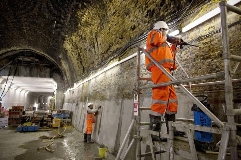 A worker drills into the original brickwork inside the Connaught Tunnel, an old Victorian tunnel which is being brought back into use for the Crossrail project. Adrian Dennis / AFP