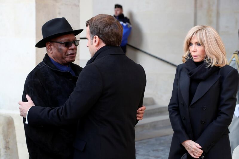 French President Emmanuel Macron hugs Mali's President Ibrahim Boubacar Keita while Brigitte Macron looks on. Reuters