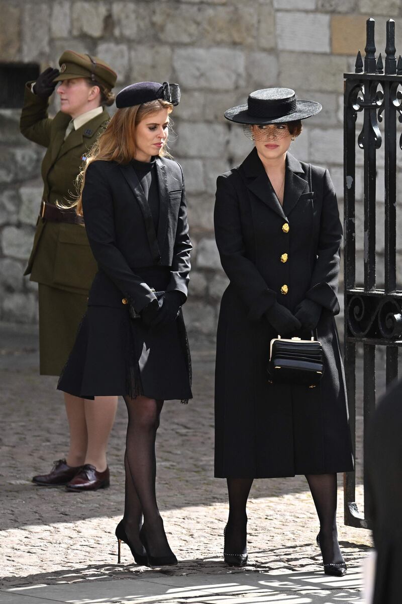 Princesses Beatrice and Eugenie leave Westminster Abbey after the queen's funeral. AFP