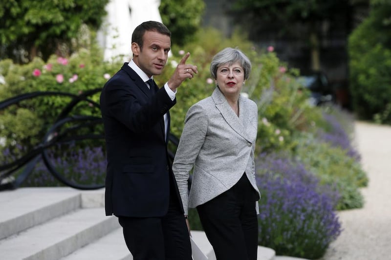 French President Emmanuel Macron, left, and Britain's Prime Minister Theresa May arrive for a joint press conference after a meeting, at the Elysee Palace, in Paris, Tuesday, June 13, 2017. After their talks, the two leaders will watch a France-England football match at the Stade de France that will honor victims of extremist attacks in both countries. (AP Photo/Thibault Camus)