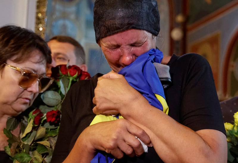 The mother of Ukrainian serviceman Abdulkarim Gulamov, who was killed in a fight against Russian troops in Kherson, attends his funeral in Kyiv. Reuters