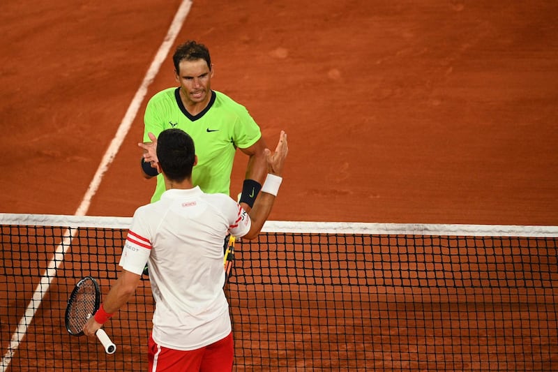 Djokovic and Nadal shake hands at the end of the match. AFP