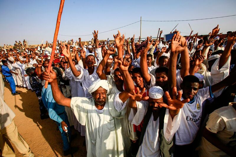 Supporters of the deputy head of Sudan's ruling Transitional Military Council (TMC) and commander of the Rapid Support Forces (RSF) paramilitaries gather and cheer for him upon his arrival in the village of Qarri, about 90 kilometres north of Khartoum.  AFP