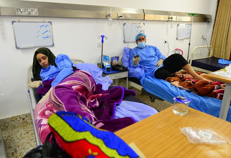 Iraqi coronavirus patients rest at a special ward at the Hakim Hospital in Najaf.  AFP