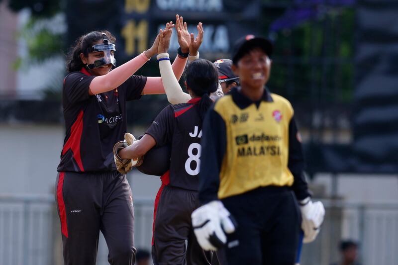 Esha Oza of the UAE celebrates the wicket of Wan Julia of Malaysia in Sylhet. 