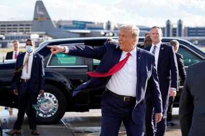 President Donald Trump gestures to supporters as he arrives at Minneapolis Saint Paul International Airport, Wednesday, Sept. 30, 2020, in Minneapolis. (AP Photo/Alex Brandon)