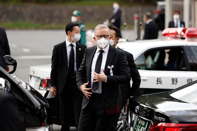 Australia's Prime Minister Anthony Albanese (C) arrives for the funeral. AFP