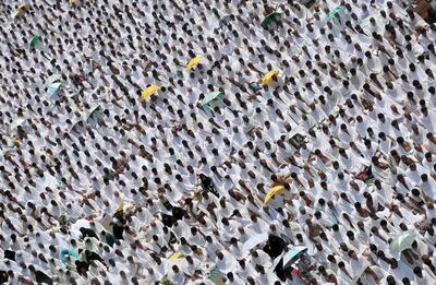 Muslim worshipers, some carrying umbrellas to protect them from the scorching sun, gather for prayer at Namirah mosque near Mount Arafat, also known as Jabal al-Rahmah (Mount of Mercy), where the Prophet Mohammed is believed to have given his final sermon, on August 31, 2017, ahead of the climax of hajj. 
Clad in white, their the palms facing the sky, some two million Muslims from around the world gathered on Saudi Arabia's Mount Arafat for the highlight of the hajj pilgrimage. / AFP PHOTO / KARIM SAHIB