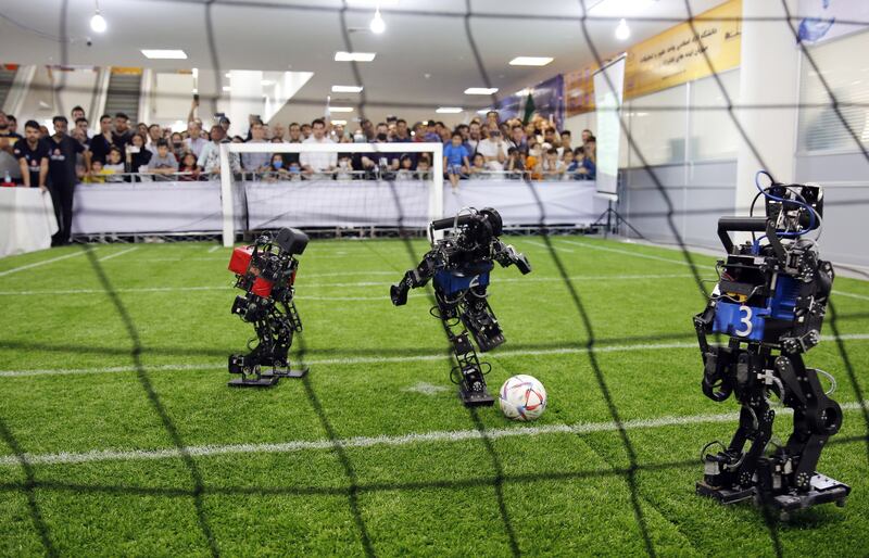 A robot soccer match between Iran MRL team (in red) and Russia Starkit team (in blue) during the 17th International Iran Open Robocup 2023, in Tehran, Iran, 27 April 2023.  The event takes place at Tehran's Azad university from 26 to 28 April with the participation of 12 teams from foreign universities and schools and hundreds of Iranian teams.   EPA / ABEDIN TAHERKENAREH