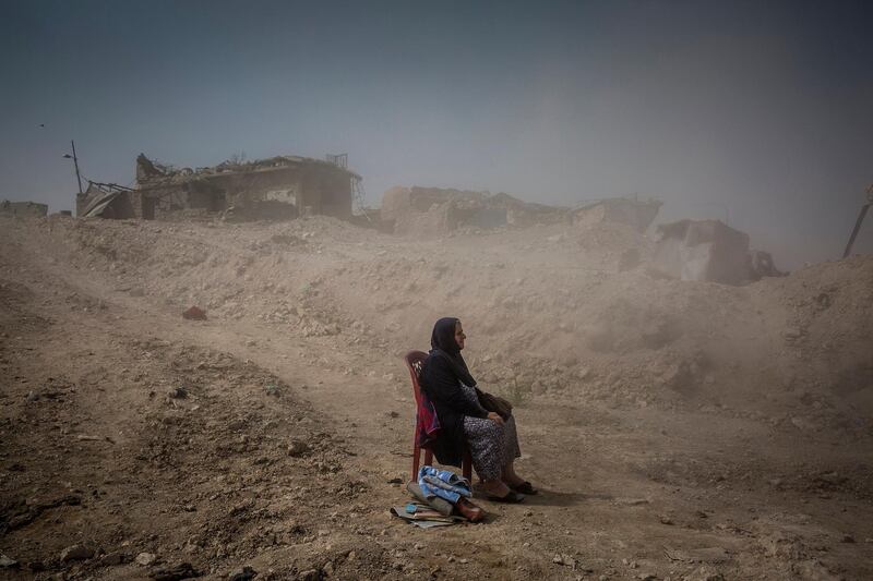 Ivor Prickett claimed the top spot in the 'General News - Stories' category. His picture shows Nadhira Aziz as she looked on as Iraqi Civil Defence workers dug out the bodies of her sister and niece from her house in the Old City where they were killed by an airstrike in Mosul. EPA/IVOR PRICKETT/NEW YORK TIMES