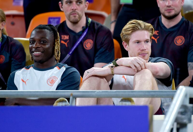 Manchester City's Jeremy Doku and Kevin De Bruyne in the stands. PA 