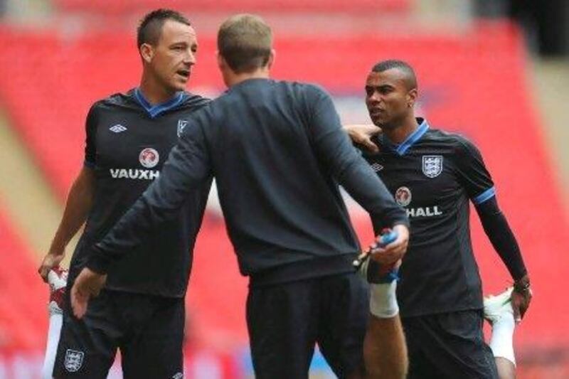 John Terry, still friends with Ashley Cole, right, has been banned for four weeks on racism charges but can appeal.