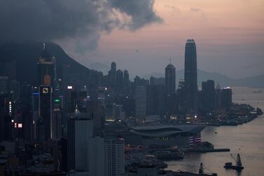 Commercial and residential buildings stand in Hong Kong. The number of Hong Kong residents with at least ten million Hong Kong dollars (Dh4.68 million) in liquid assets, bank deposits, mutual funds, stocks and bonds, rose 1.5 per cent to 69,000, according to a recent survey. EPA