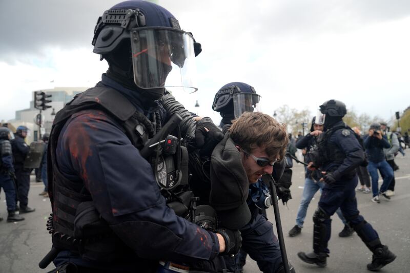 A protester is detained during a demonstration. AP