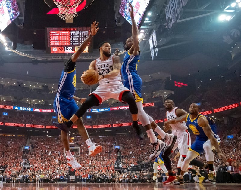 Toronto Raptors guard Fred VanVleet (23) grabs a rebound under pressure from Golden State Warriors forward Kevin Durant (35) and center Kevon Looney (5) during Game 5 of the NBA Finals in Toronto. AP Photo