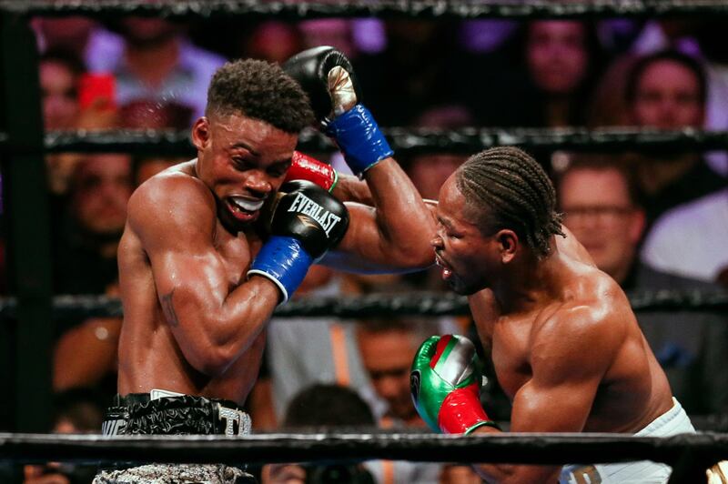 Errol Spence Jr, left, attempts to block a punch from Shawn Porter during their  welterweight world title fight in Los Angeles. EPA