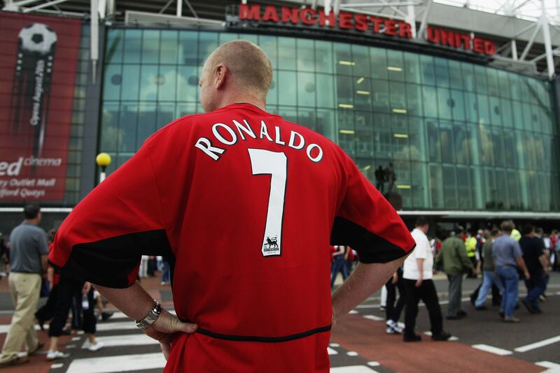 A Manchester United fan wears the shirt of new signing Cristiano Ronaldo outside Old Trafford in 2003. Getty Images