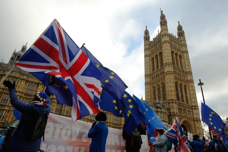 Anti-Brexit demonstrators wave European Union (EU) flags and British Union flags, also known as a Union Jacks, outside the Houses of Parliament in London, U.K., on Wednesday, Jan. 9, 2019. May resumes her bid to win Parliament's support for her Brexit deal, a day after lawmakers voted to make it harder for the U.K. to crash out of the European Union without an agreement. Photographer: Luke MacGregor/Bloomberg