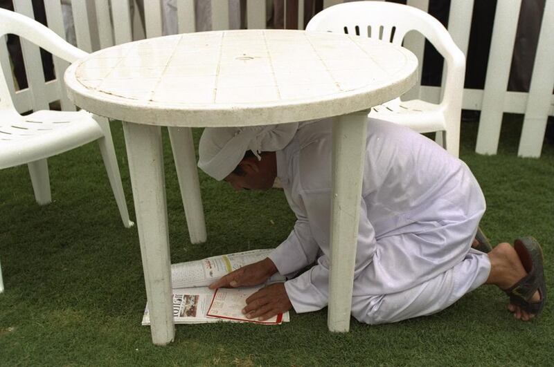 A man studies form in the rain at the second Dubai World Cup at the Nad Al Sheba racecourse in 1997. Julian Herbert / Allsport