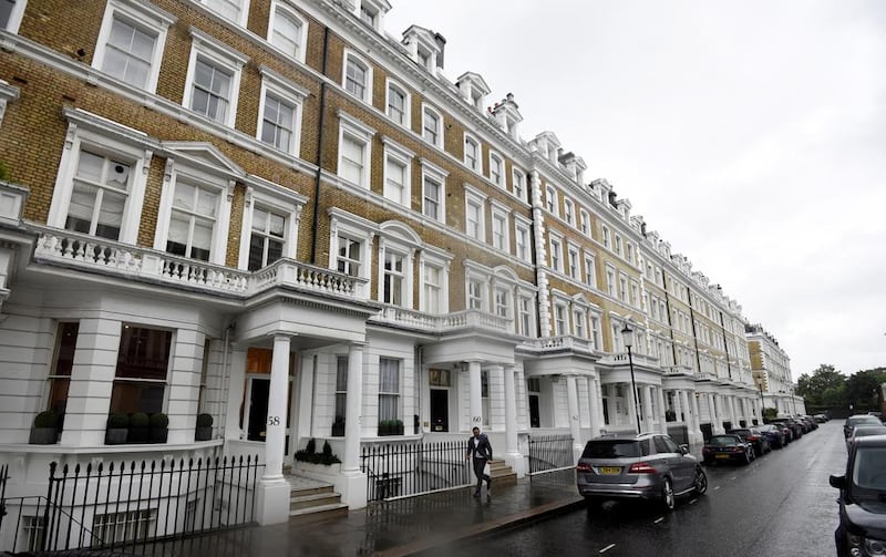 A man walks along an upscale residential street in London. Hannah McKay / Reuters