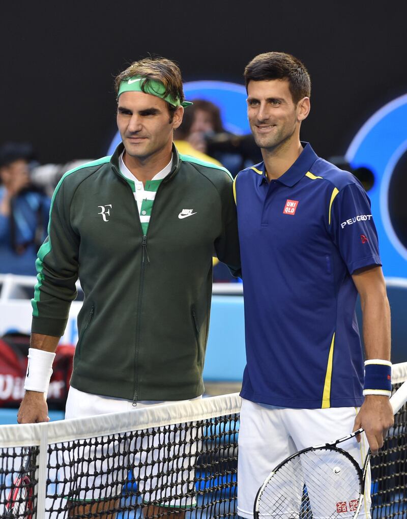 Switzerland's Roger Federer (L) poses ahead of his men's singles semi-final match against Serbia's Novak Djokovic (R) on day eleven of the 2016 Australian Open tennis tournament in Melbourne on January 28, 2016. AFP PHOTO / SAEED KHAN-- IMAGE RESTRICTED TO EDITORIAL USE - STRICTLY NO COMMERCIAL USE (Photo by SAEED KHAN / AFP)
