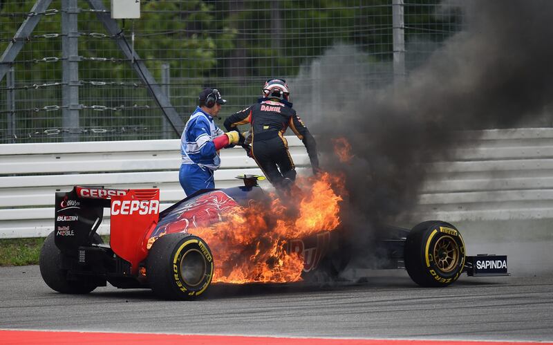 Daniil Kvyat of Scuderia Toro Rosso jumps out of his burning car. Getty Images