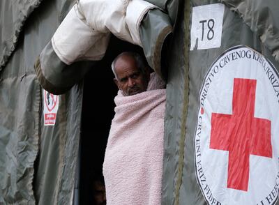 A migrant walks through the Lipa camp, outside Bihac, Bosnia.  Thousands of migrants, including many Afghans, are stranded in Bosnia and other Balkan countries while trying to reach wealthy European nations in search of a better future.  Photo: AP