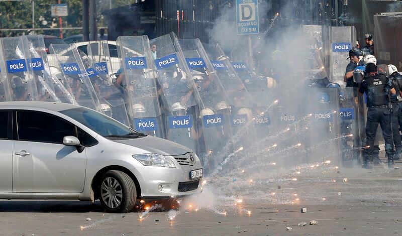 Riot police behind shields fire tear gas as they clash with anti-government protesters at Taksim square in central Istanbul June 1, 2013. Turkish Prime Minister Tayyip Erdogan made a defiant call for an end to the fiercest anti-government demonstrations in years on Saturday, as thousands of protesters clashed with riot police in Istanbul and Ankara for a second day. REUTERS/Murad Sezer (TURKEY  - Tags: POLITICS CIVIL UNREST)