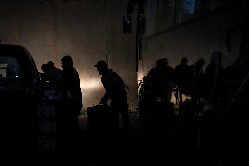 epa06689130 Syrian fighters and their families from the Eastern al-Qalamoun area prepare to leave during evacuation process, at Qalaat al-Madiq town, Hama province, Syria, 23 April 2018 (issued 24 April 2018). According to reports, over 1,000 militants and family members were evacuated on 23 April from Eastern al-Qalamoun area of Damascus to a gathering area at Qalaat al-Madiq town of Hama province before heading to temporary settlement in Idlib province. Around 4,000 militants and their family members had so far left Eastern Qalamoun since 20 April under an agreement with the Syrian government and Russia after handing over their heavy and medium weapons and ammunition.  EPA/MOHAMMED BADRA