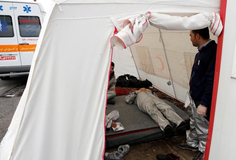 Iranian Red Crescents personnel rest in a tent. EPA