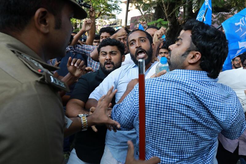 TOPSHOT - In this photo taken on January 2, 2019 Indian police disperse activists trying to burn an effigy of Kerala's Chief Minister Pinarayai Vijayan, at a protest after two women entered the Sabarimala Ayyapa temple, near the Police Commissioner’s Office in Kochi. One person was killed and at least 15 injured in violence across southern India's Kerala state which broke out after two women defied traditionalists to enter one of Hinduism's holiest temples, police said January 3.
 / AFP / STR
