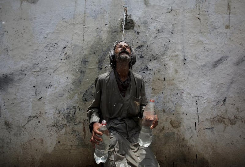 While the provincial government announces a public holiday to encourage people to remain indoors, those outdoors use public taps to keep cool off as the heatwave in Pakistan claims nearly 700 lives. Akhtar Soomro / Reuters;