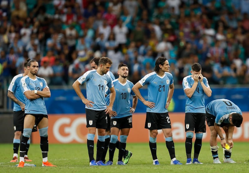 Uruguay players react after losing the penalty shootout to Peru. AP Photo