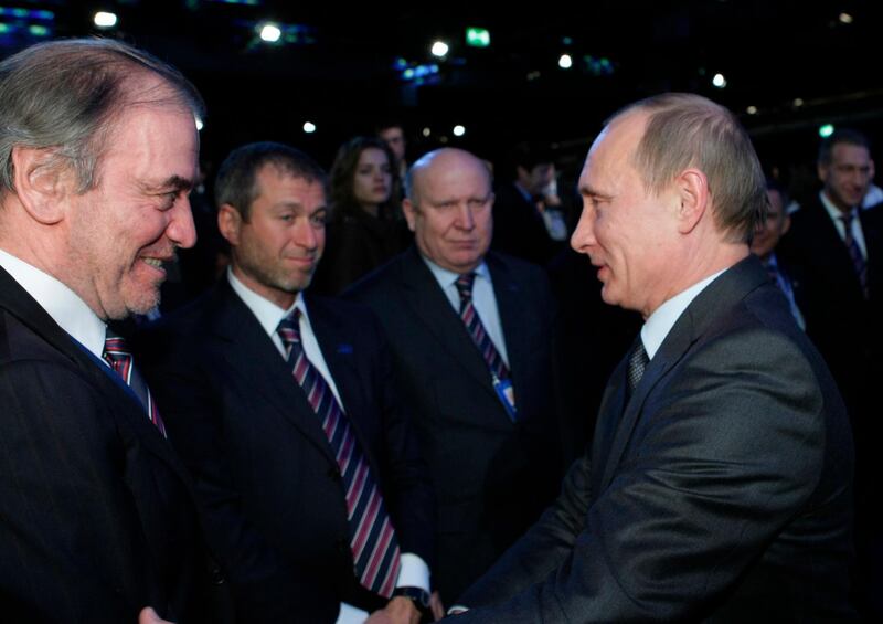 File - In this Dec. 2, 2010 file photo, then Russian Prime Minister Vladimir Putin, right, congratulates members of the Russian delegation, from left: conductor Valery Gergiyev, businessman Roman Abramovich and Nizhny Novgorod governor Valery Shantsev; after it was announced that Russia would host the 2018 soccer World Cup, in Zurich, Switzerland. The sudden immigration to Israel of billionaire Abramovich makes him the latest in a string of Jewish Russian oligarchs who have made a home in the country in recent years. Abramovich, who has an estimated net worth of more than $11 billion, received Israeli citizenship upon arrival Monday, May 28, 2018. The Chelsea football club owner made the move after his British visa was not renewed, apparently as part of British efforts to crack down on associates of Putin. (AP Photo/Alexei Nikolsky, Pool, File)