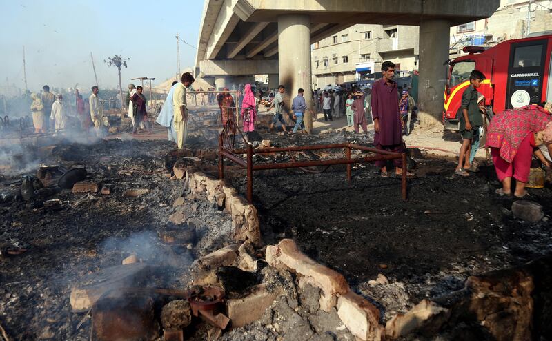 The fire reduced the dwellings along the Lyari River, in the Teenhatti neighbourhood, to debris. EPA