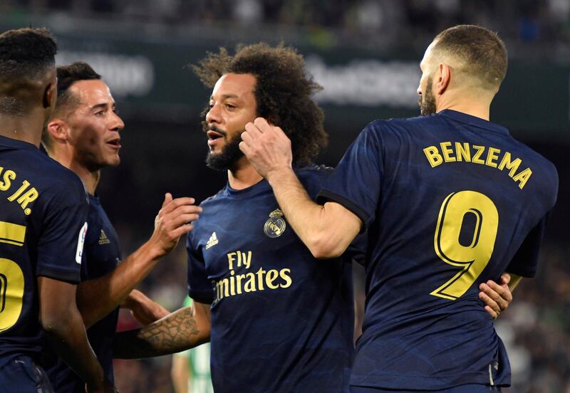 7. Real Madrid - 3741 points. Striker Karim Benzema (R) celebrates with his teammates. EPA