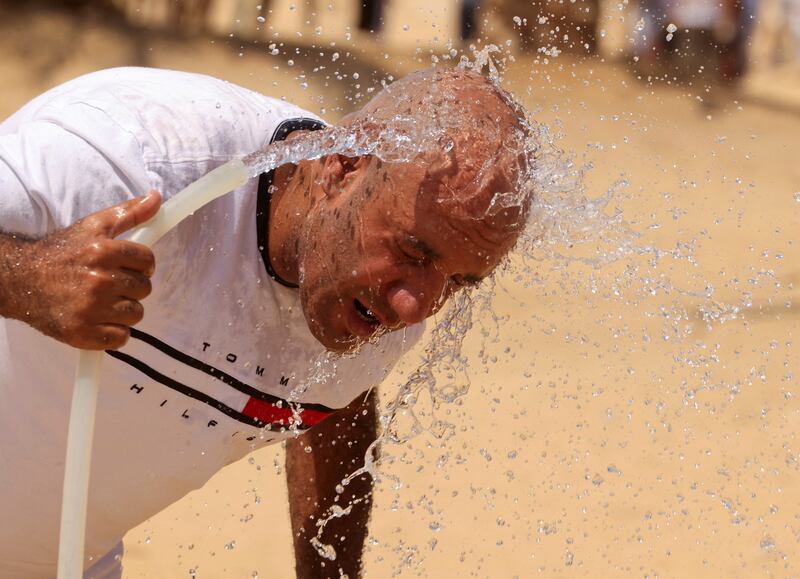 A man cools himself with water, amid a heatwave in Al Fayoum Governorate, southwest of Cairo. Reuters