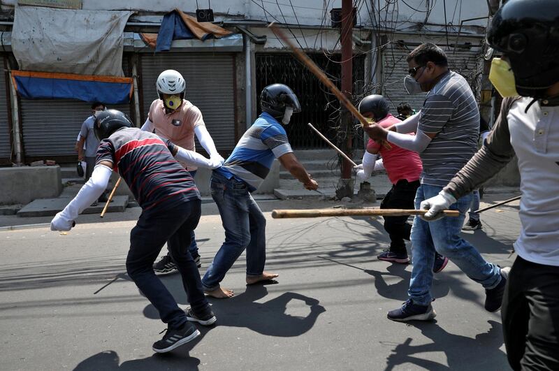 Plain clothes policemen wield their batons against a man for defying the lockdown imposed by the government to slow the spreading of coronavirus disease at Howrah on the outskirts of Kolkata, India. Reuters