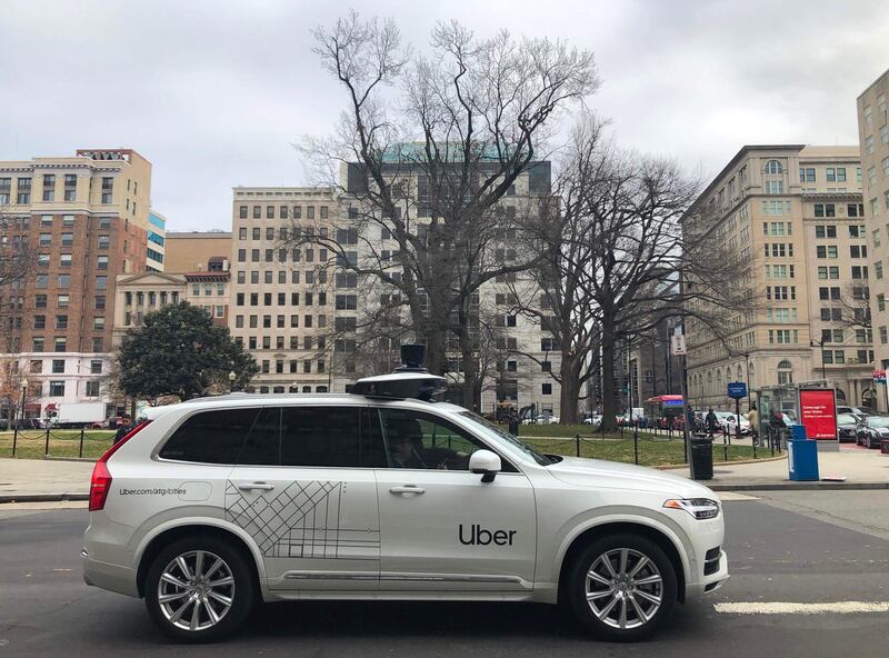(FILES) In this file photo taken on January 24, 2020 an Uber car equipped with cameras and sensors drives the streets of Washington, DC. Uber agreed to sell its autonomous car division to Aurora in a deal that gives the ride-hailing giant a stake in the startup developing self-driving technology, the companies said December 7, 2020. / AFP / Eric BARADAT
