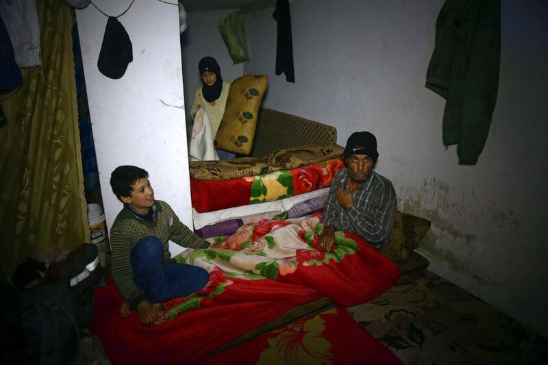 A man gestures as he sits in a shelter in the besieged town of Douma on March 11, 2018. Bassam Khabieh / Reuters