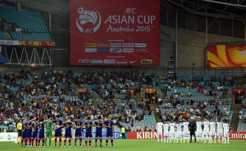 Japan and the UAE line up for national anthems prior to their Asian Cup quarter-final match on Friday. Saeed Khan / AFP