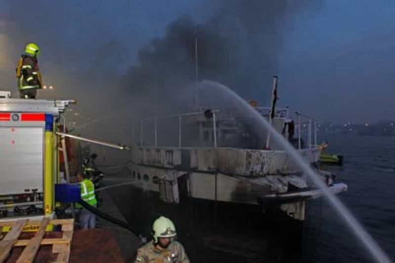 Dubai, 8th March 2011.  A cargo dhow on fire, along the busy creek.  (Jeffrey E Biteng / The National)