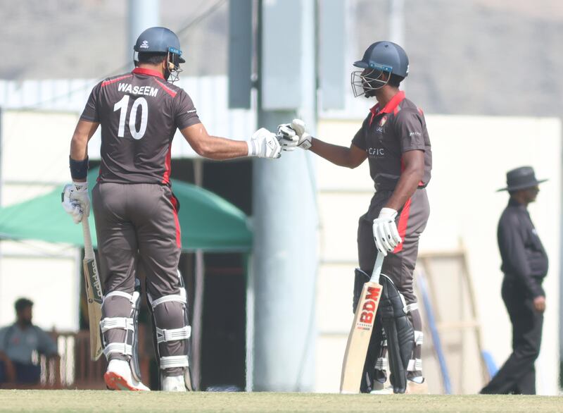 Muhamed Waseem and Vriitya Aravind touch gloves during the T20 World Cup Qualifier.