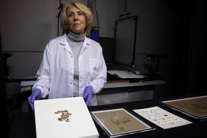 Israel Antiquities Authority conservator Tanya Bitler shows newly discovered Dead Sea Scroll fragments at the Dead Sea scrolls conservation lab in Jerusalem. AP Photo