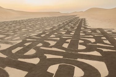 Artist Nathaniel Alapide transformed Dubai's sand dunes with Burberry's TB monogram logo. Courtesy Burberry