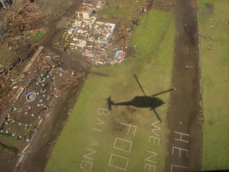 The shadow of a U.S. military helicopter on a disaster relief mission is cast over a sign pleading for help near Tacloban, Philippines. The U.S. military has launched a massive relief effort for victims of Typhoon Haiyan in an effort to both save lives and build relations with its allies around the region by showing that it has the military strength to provide support in times of need. Eric Talmadge /AP Photo