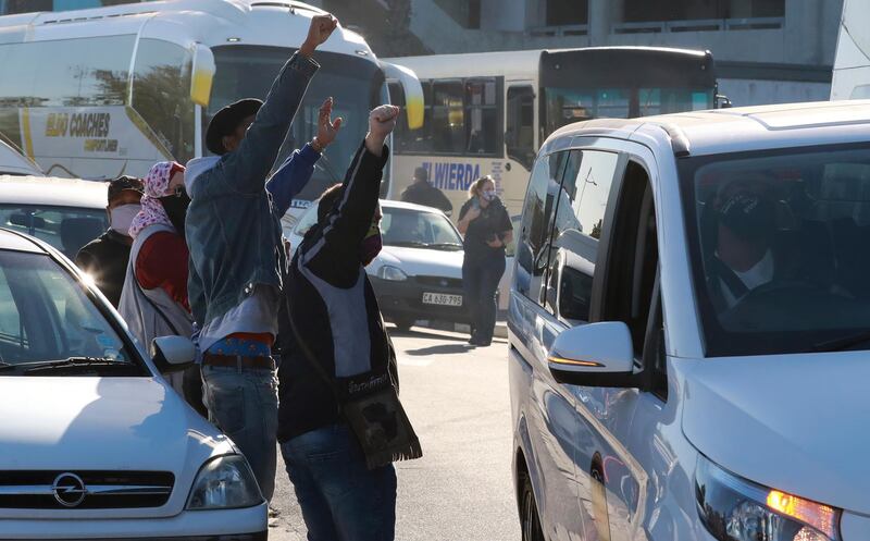 Tour operators take part in a protest in Cape Town, South Africa, Friday July 31, 2020. Various tourism operators staged a slow drive protest as they struggle to make ends meet under the COVID-19 lockdown regulations. AP Photo